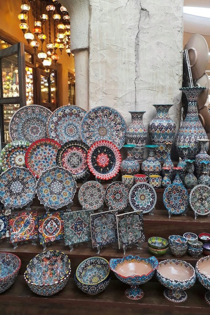 Colorful handmade ceramics on display at a Dubai market, showcasing intricate patterns and craftsmanship.